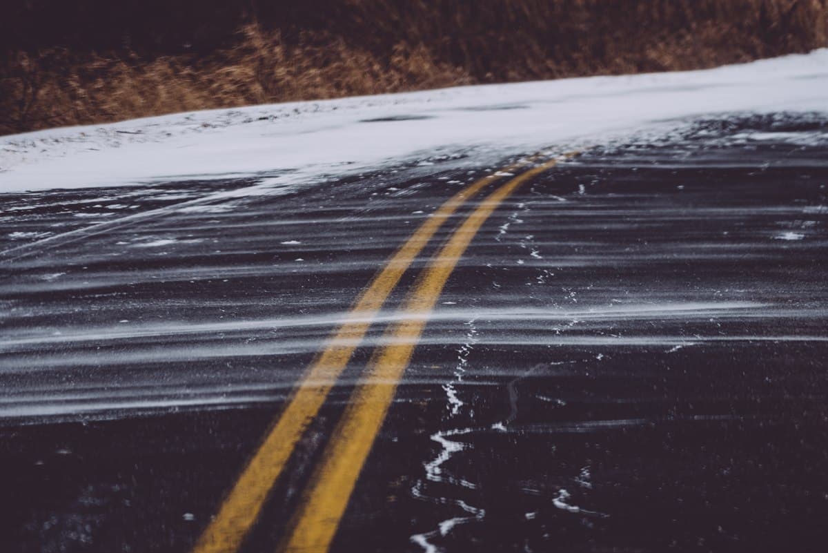 Snow drifting across a road during wind chill tomorrow by zip code conditions