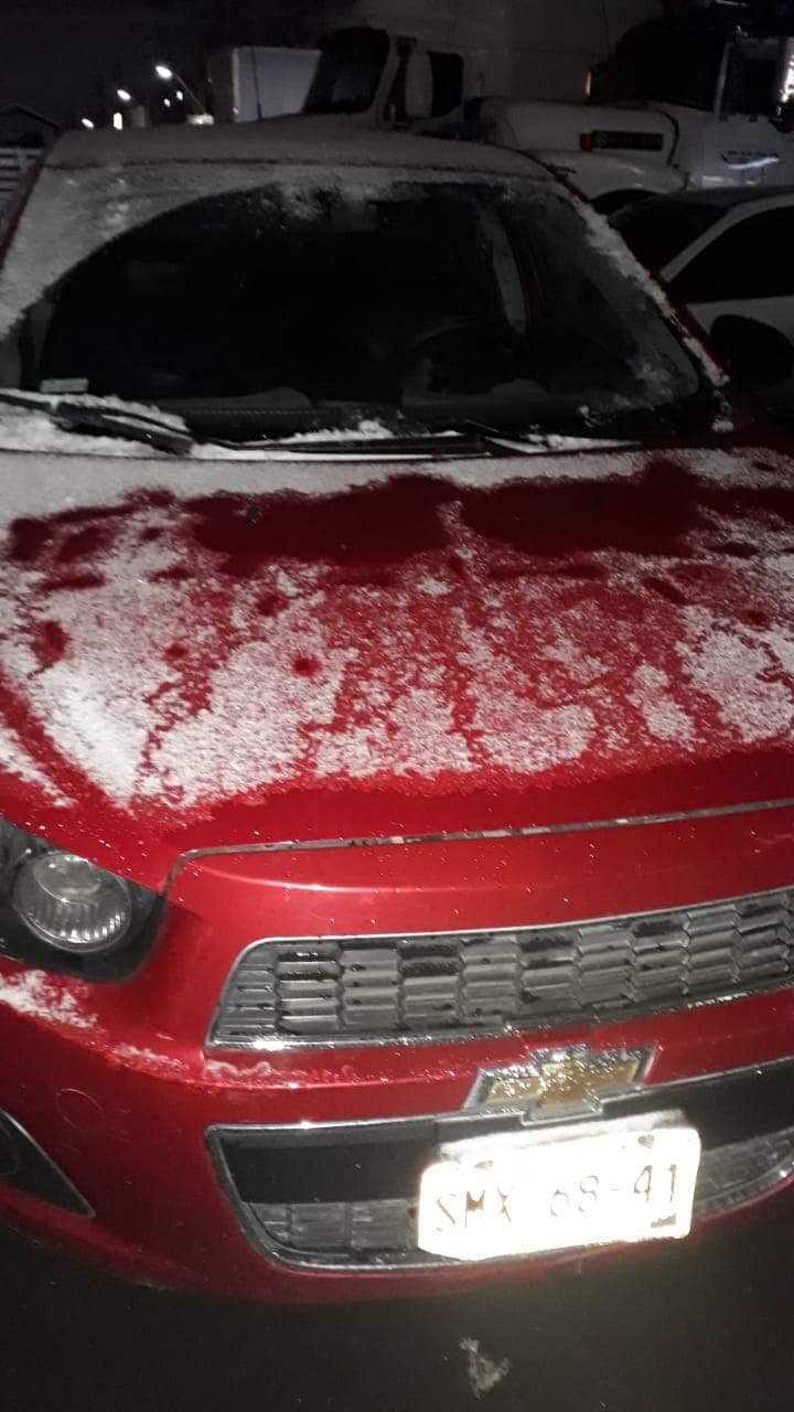 Snow-covered vehicle showing why a winter car emergency kit checklist matters before road trips